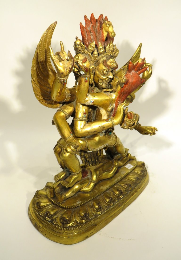 CHINESE IMPORTANT EROTIC GILT BRONZE BODHISATTVA: Chinese Important Erotic Gilt Bronze Bodhisattva: Two multi handed figures embrace over two prone copulating figures. Decorated with cabochon stones accented with red paint. Winged figure has three h