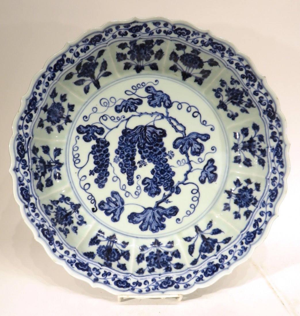 MING DYNASTY STYLE BLUE AND WHITE SHALLOW BOWL: Ming Dynasty Style Blue And White Shallow Bowl: A shallow vessel with bracket-lobed mouth rim, with further twelve detached floral sprays repeated radiating around the low foot ring, the broad invert