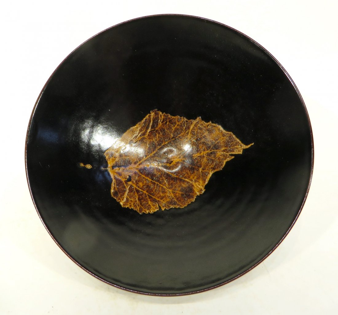 CHINESE JI ZHOU TYPE BOWL: Chinese Ji Zhou Type Bowl: The simple shallow bowl shape, raised on narrow foot ring, the interior decorated with a naturalistic leaf decoration. A pre-rotted leaf with only the skeletal remains. It