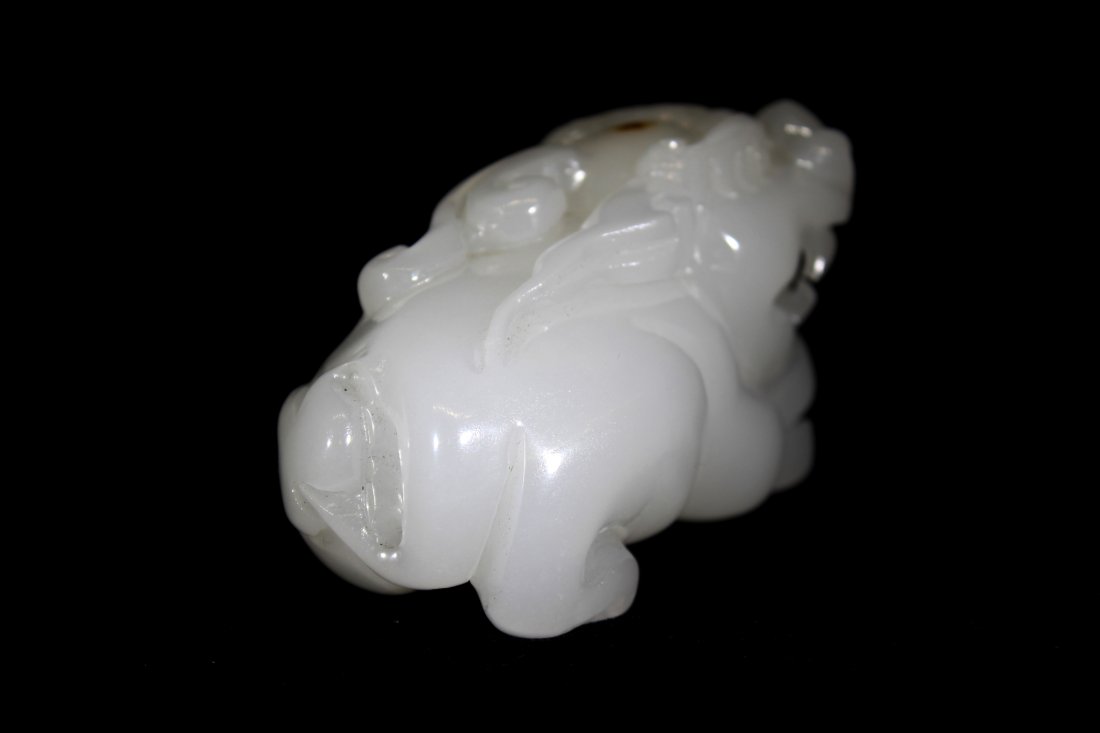 JADE FOO CARVING: Jade Foo Carving: A large foo dog baring its teeth in a guarded position. Has detailed features, paws, and horns with a small brown inclusion on his head. 4"