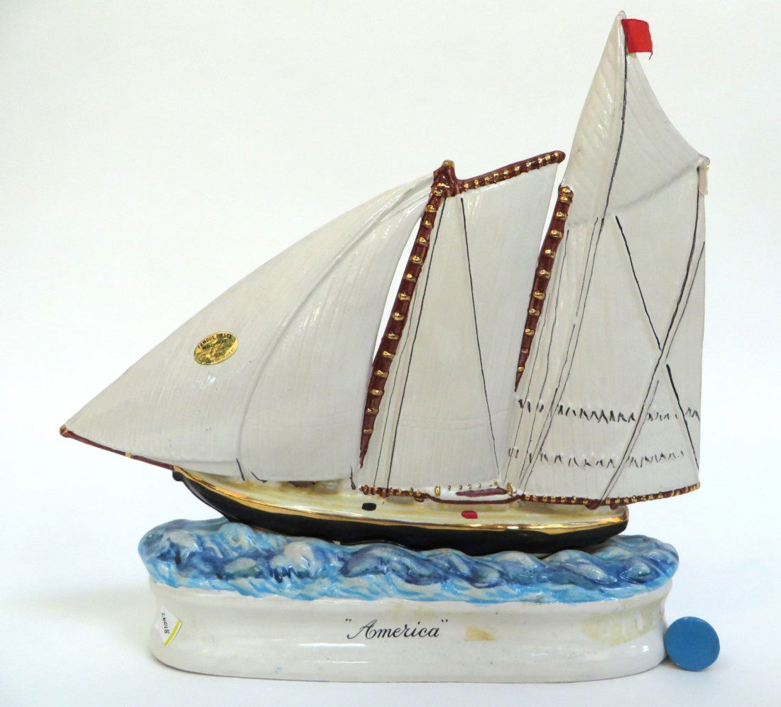 BRANDY SAUCE BOTTLE: THE SHIP "AMERICA": Brandy Sauce Bottle: The Ship "America": The yacht "America". sails on a brandy sauce-filled ocean with cork stoppered waves. 4/5 Quart. Comes with an extra cork. States on the