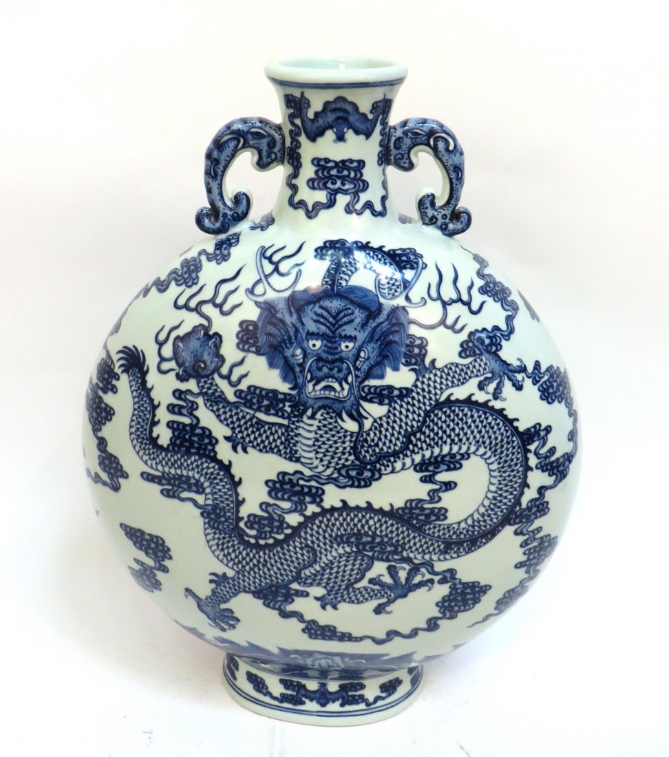 CHINESE QIANLONG BLUE AND WHITE MOON FLASK: Chinese Qianlong Blue And White Moon Flask: Dragon decorated moon flask with elephant head handles. A fierce-looking central dragon flies among flames over undulating water. Bats border the top. Mark