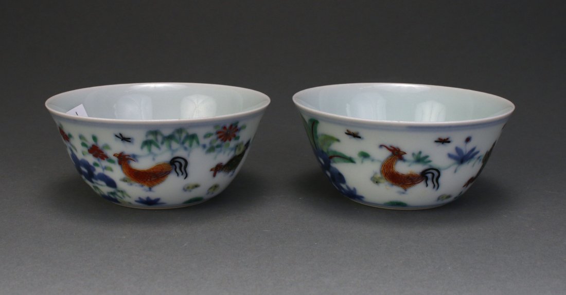 PAIR OF CHINESE DOUCAI ROOSTER CUPS: Pair Of Chinese Doucai Rooster Cups: Chinese doucai porcelain cups with rounded sides rising to a slightly flaring rim. The exterior painted with continuous scenes of hens, roosters and peonies. Mark