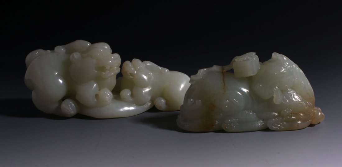 CHINESE HAND CARVED JADE ANIMALS: Chinese Hand Carved Jade Animals: Fine carved Chinese white jade a larger and smaller foo dog facing each other in a crouching position baring their teeth. 3 1/2" X 1