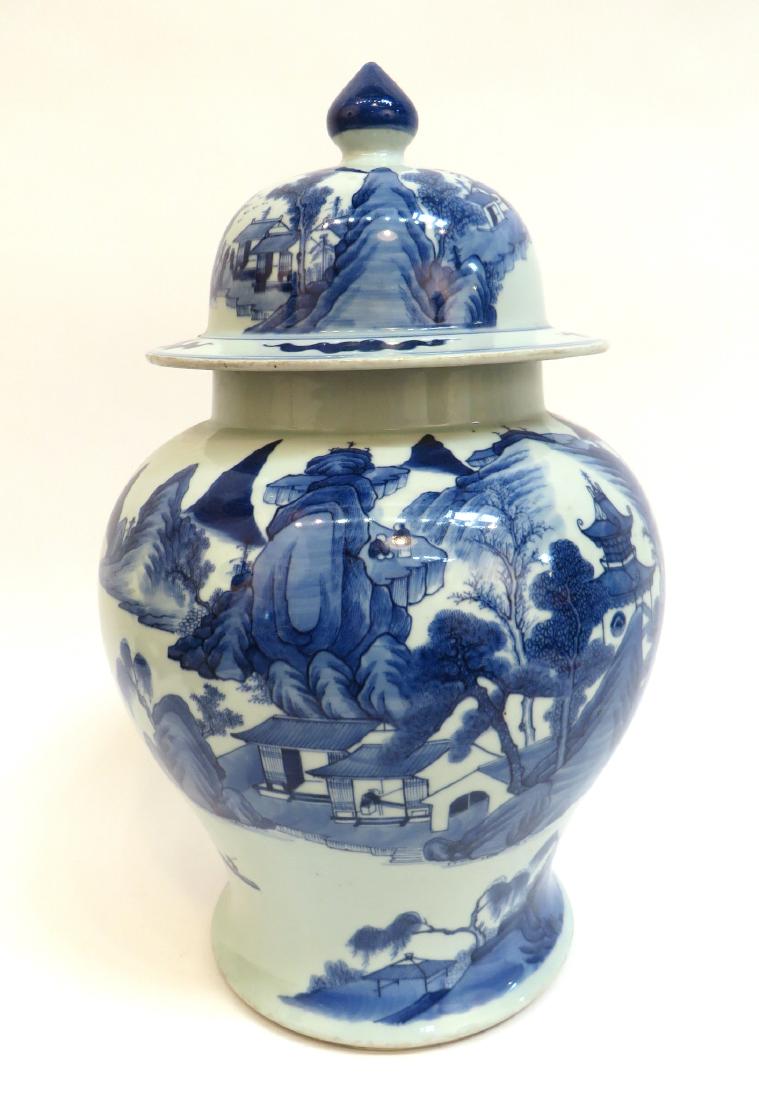 CHINESE BLUE & WHITE GINGER JAR: Chinese Blue & White Ginger Jar: Fine Chinese Qian Long style blue and white lidded ginger jar. The lid is a tall bell shape with a finial in blue. The exterior depicts a small village in a mount
