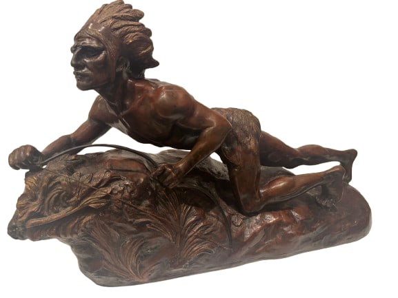 R. Varnier Bronze Indian Sculpture: Rene Andre Varnier bronze sculpture of a Native American Indian on the hunt, the figure is crawling on the ground and carrying his bow; has a cold painted finish, signed