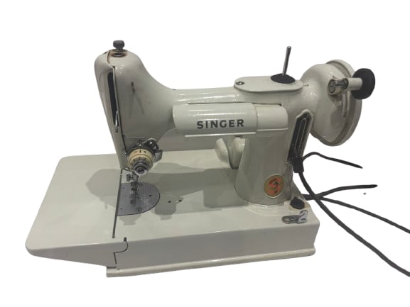 221 k Singer Featherweight sewing machine: A solid, vintage Singer electric sewing machine, finished in the classic white enamel with chrome detailing. Built by Singer, these machines are renowned for their durability, smooth stitching, and lo