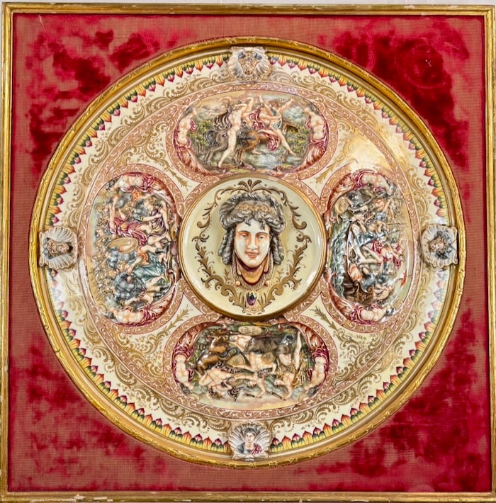 Renaissance Revival Medusa Majolica Charger: This ornate Majolica charger features a central relief of Medusa, surrounded by four detailed mythological scenes in vivid, polychrome glaze. possibly Urbino or Deruta style, known for narrative scene