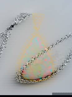 Exquisite 11.46ctw Platinum Australian Opal & Diamond Pendant | 10.38ct Fiery Opal Center!: Prepare to be mesmerized by this dazzling platinum pendant, showcasing a vibrant 10.38 carat Australian opal ablaze with fiery hues of red, blue, green, and gold. The opal’s breathtaking play-of-col