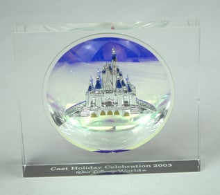 A 2003 Holiday Celebration Glass Paperweight.
