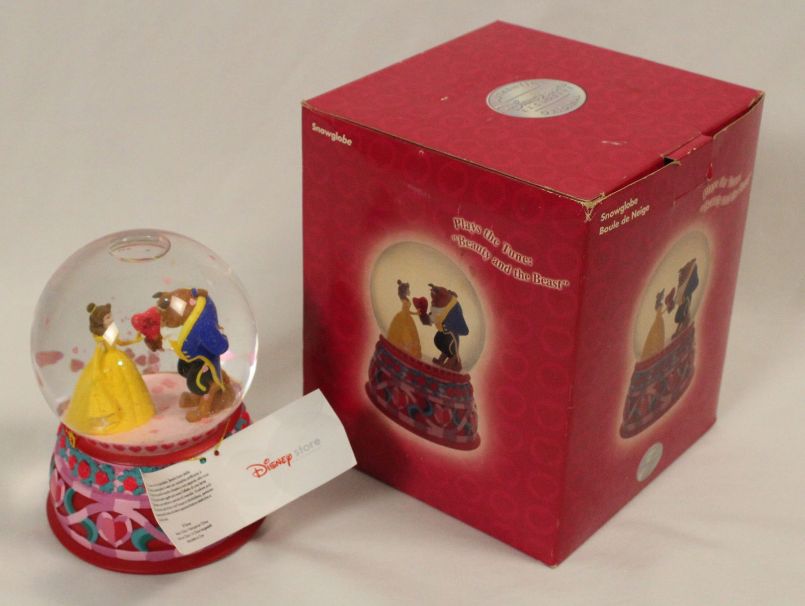 A Beauty and the Beast Snow Globe.: (Disney Store) This is a Disney Store exclusive Beauty and the Beast snow globe. The music box plays the title song, "Beauty and the Beast" It is is very fine, like new working condition. A must have