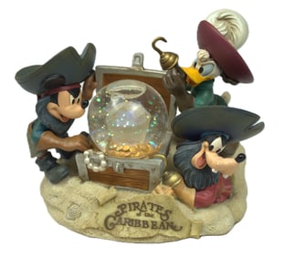A Disney Parks Pirates of the Caribbean Snow Globe.