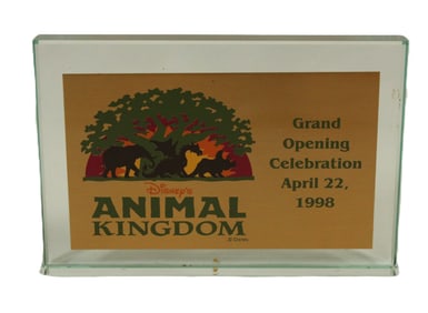 An Animal Kingdom Grand Opening Celebration Glass paperweight.