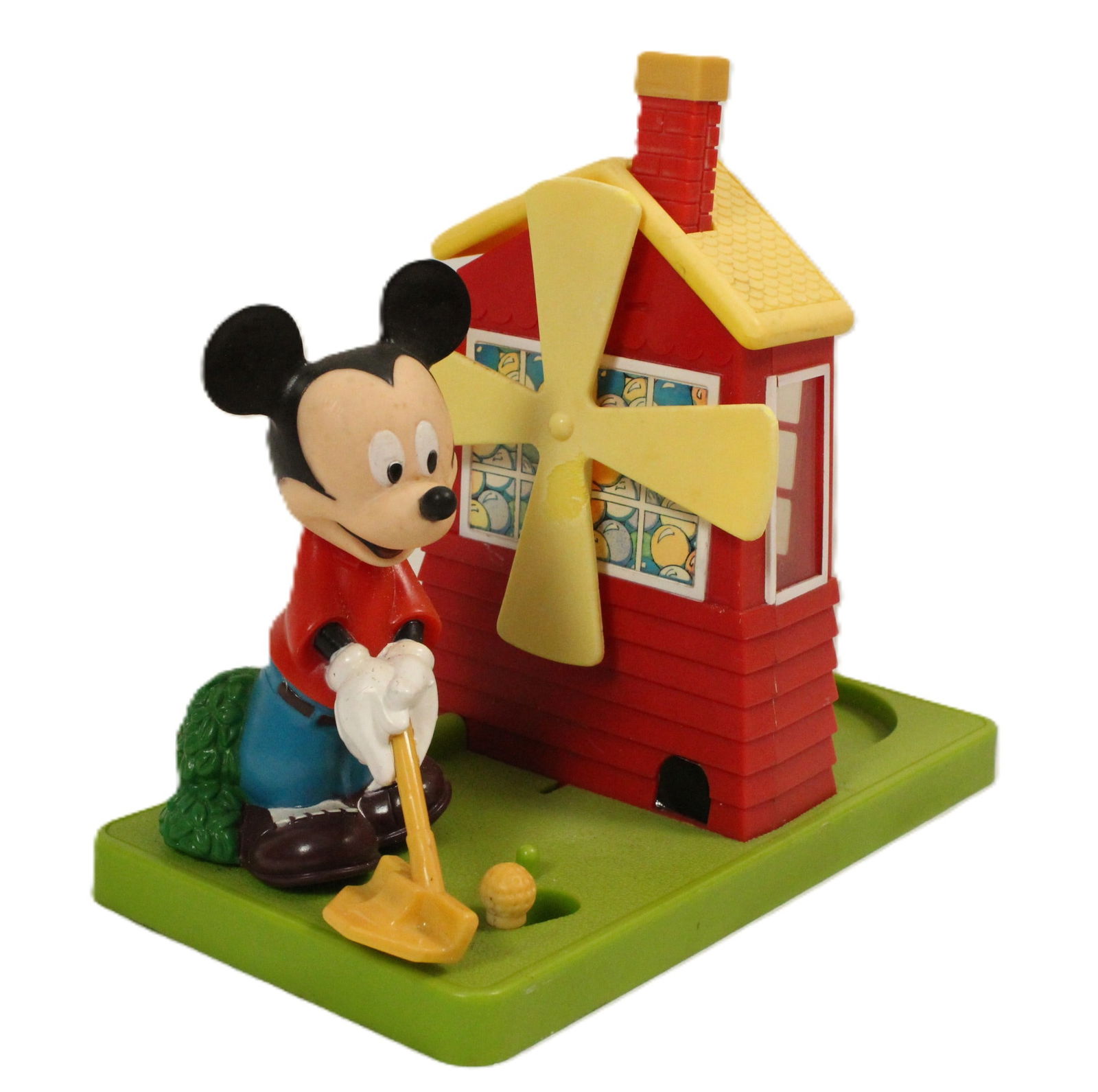 A Vintage Golfer Mickey Gumball Machine.: This is a working gumball machine by Carousel Leaf Inc. It features Mickey Mouse putting into the front of a goofy golf style windmill obstacle. When you depress the chimney, the windmill spins and a