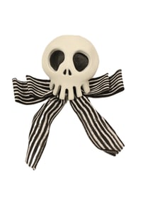 A Haunted Mansion Holiday Skull Decoration Prop Replica.