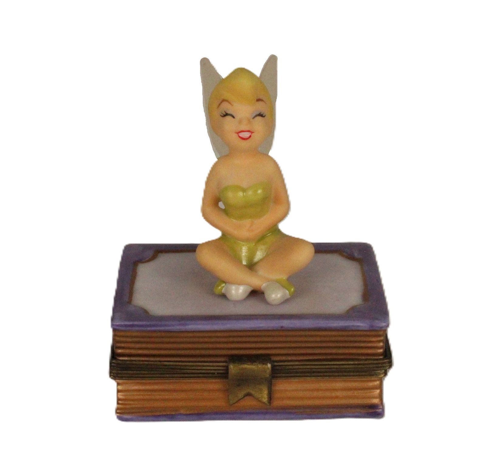 A 75th Anniversary Tinker Bell Trinket Box.: (Disney, 1998) This is a Tinker Bell trinket box crafted for the 75th anniversary of Disney. It is a porcelain hinged box and has the appearance of Tinker Bell seated on a book. Inside the trinket box