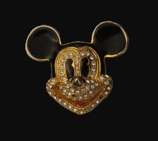 A Gold-toned Enamel and Swarovski Crystal Mickey Face Pin.