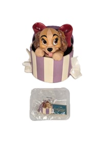 A WDCC Lady Figurine With Matching Pin.