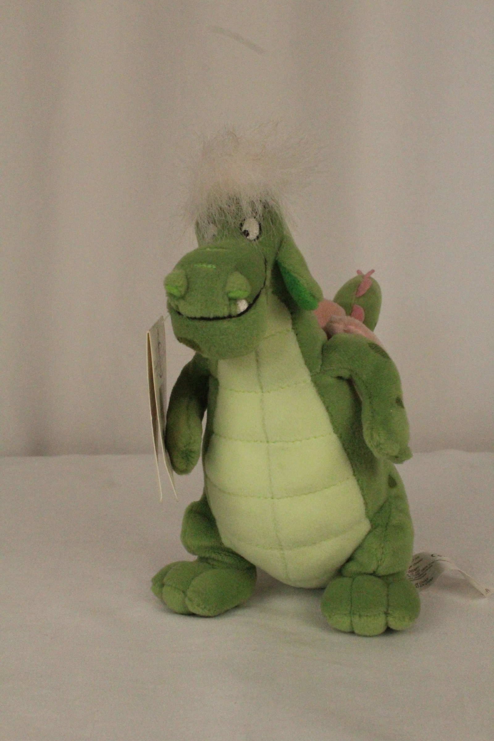 A Vintage Pete's Dragon Elliot Beanie.: (Disney Store) This is a Pete's Dragon Elliot the Dragon Beanie Doll. It appears new with original tags. It is 7” tall and in like new condition.