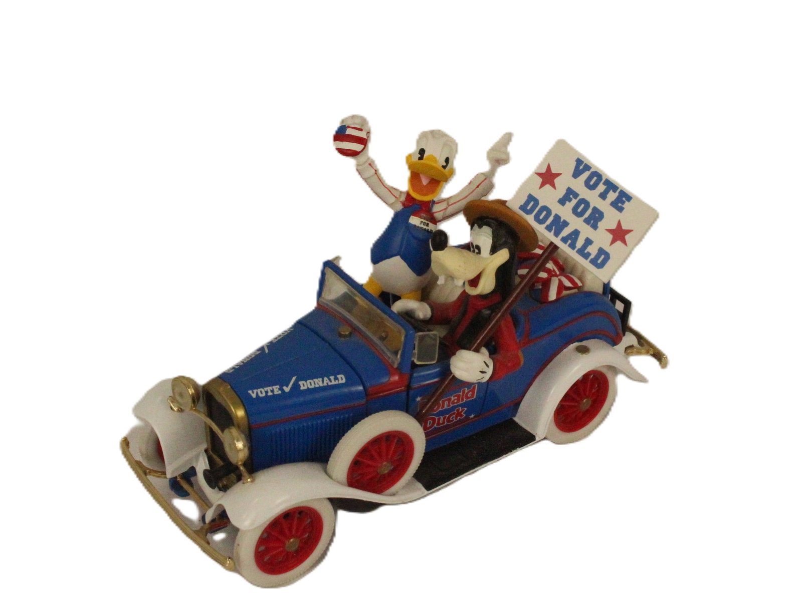 A Metal Donald and Goofy In Roadster.: (Mickey and Co. Ertl) This is Metal 1930s-style roadster with Goofy at the wheel and Donald sitting next to him. Goofy holds a removable Vote for Donald sign. Donald is removable. The hood is also rem