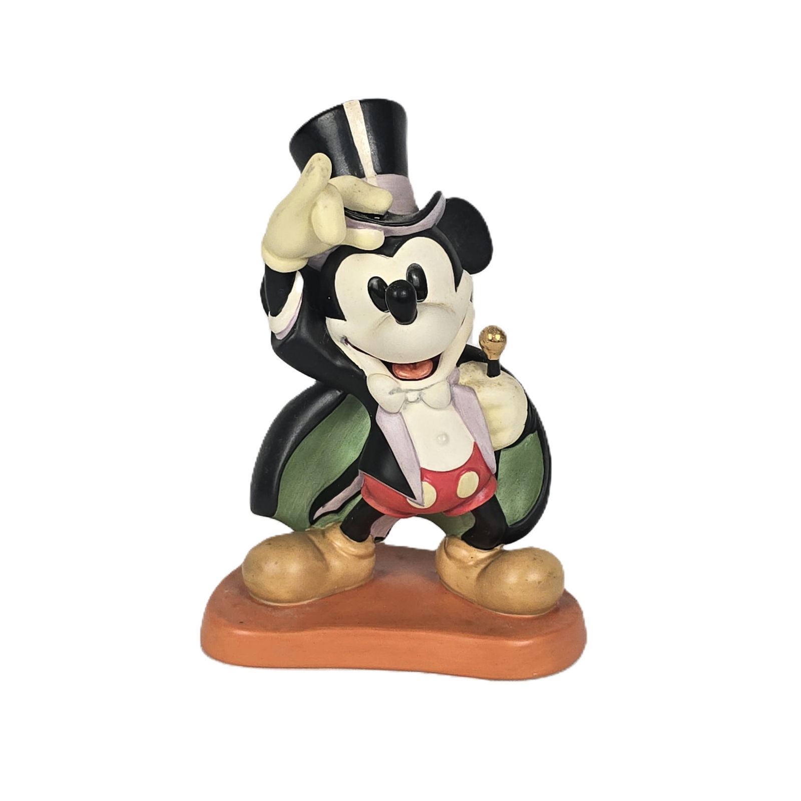 A WDCC Magician Mickey Figurine and Matching Pin.: (WDCC, 1997) This is a Magician Mickey figurine titled “On With The Show!”. It features gold metallic paint on the wand and is in very fine condition. It includes the matching collector pin. I