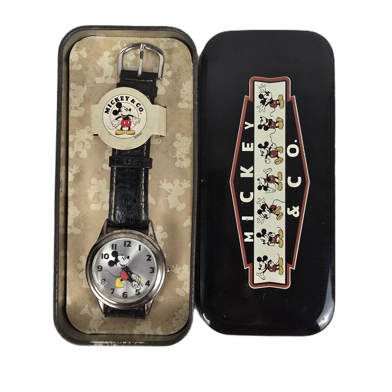 A Silver-toned Mickey and Co Watch.: (Mickey and Co/Fossil) This is a silver-tone watch with a silver face. It features a sideways facing Mickey Mouse whose arms are the dial arms pointing out the time. The watch is in good condition and