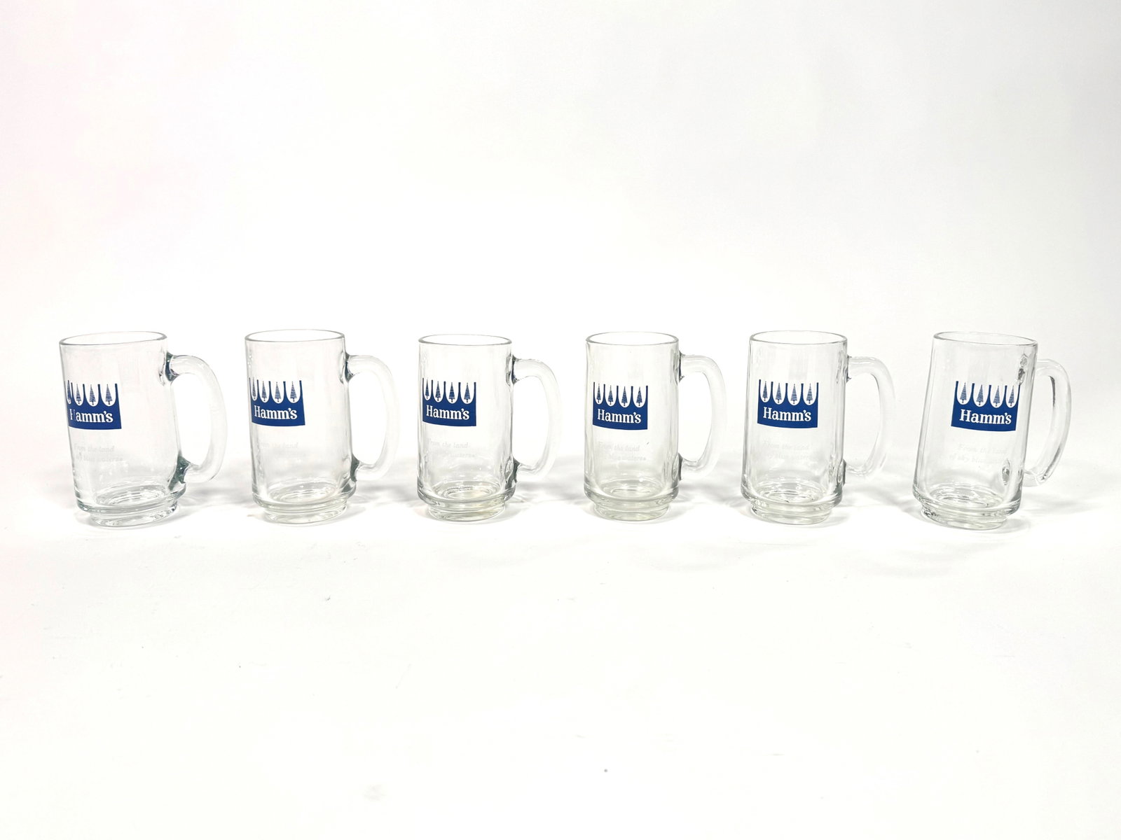 Lotta six circa 1960s Hamm’s Beer glass Tavern mugs.: A lot of six 1960s Hamm’s Beer glass Tavern mugs. Possibly never used. Condition: 9.25+. Size: 5” x 6” x 3.5”.