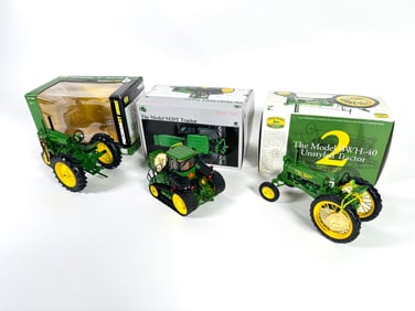 Lot of three John Deere Ertl Die-Cast tractors with boxes