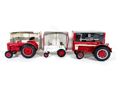 Lot of three International Harvester Diecast Tractors by Ertl with boxes