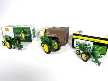 Lot of three John Deere Ertl Die-cast tractors with boxes