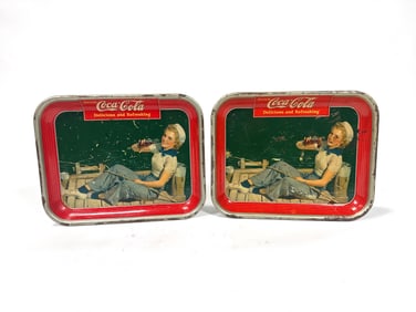 Lot of two 1940 Coca-Cola sailor girl metal serving trays.