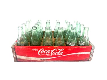 Original 1960s Coca-Cola wooden bottle case with 22 earlier 8.5 ounce and Bob’s bottles.