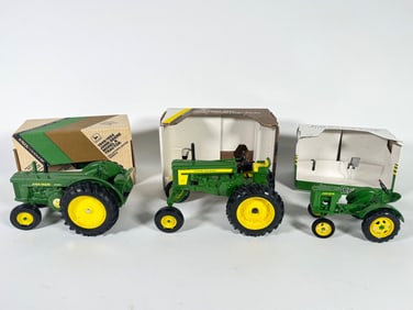 Lot of three John Deere Diecast tractors by Ertl with boxes