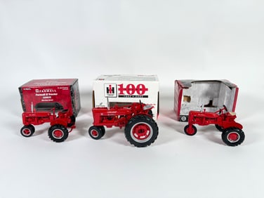 Lot of three McCormick Farmall Die-Cast Metal Tractors by Ertl and Case with boxes
