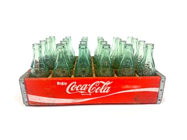 Original 1960s Coca-Cola wooden bottle case with 24 earlier 8.5 embossed glass soda bottles.