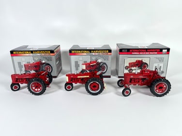 Lot of three International Harvester McCormick Farmall tractors by SpecCast with boxes