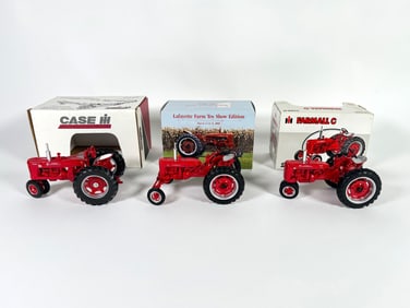 Lot of three McCormick Farmall Die-Cast Metal Tractors by Ertl and Case with boxes