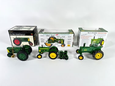 Lot of three John Deere tractors by Ertl with boxes
