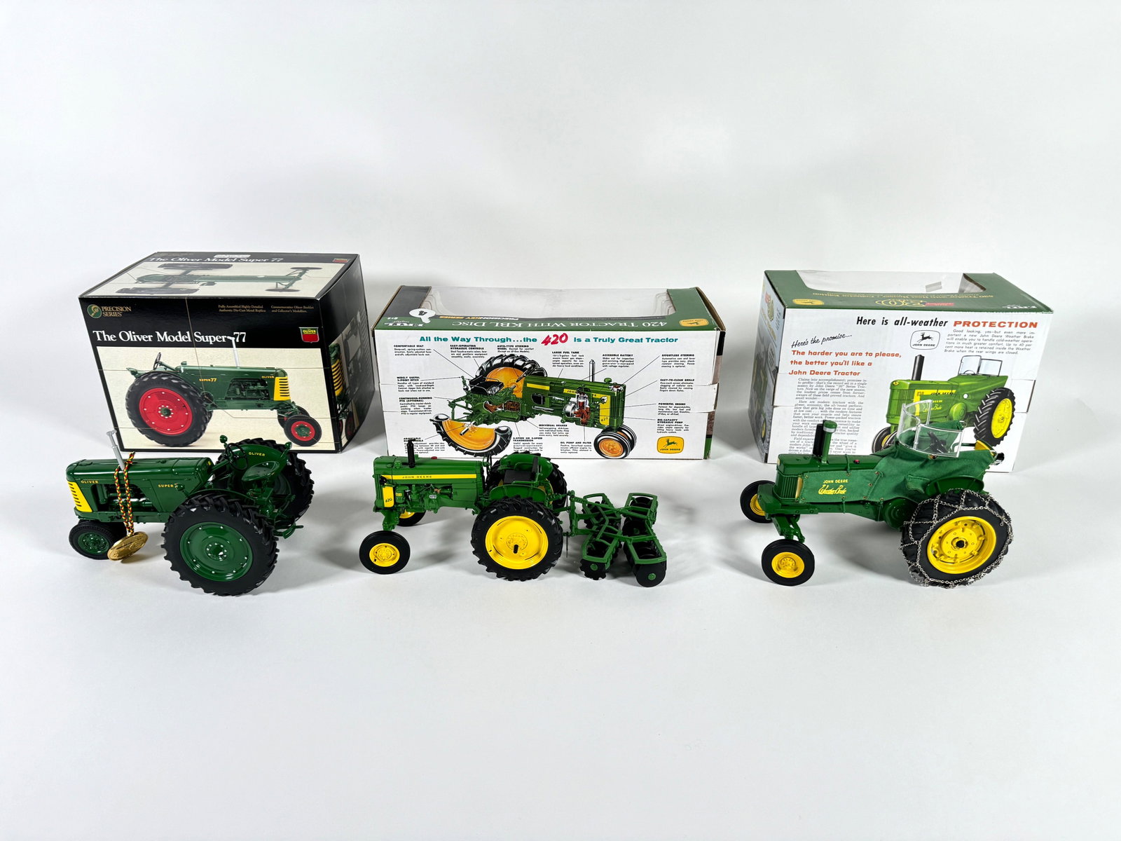 Lot of three John Deere tractors by Ertl with boxes (1 of 2)