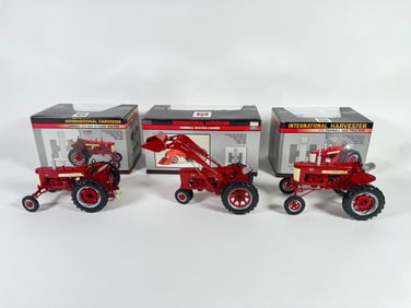 Lot of three International Harvester McCormick Farmall tractors by SpecCast with boxes