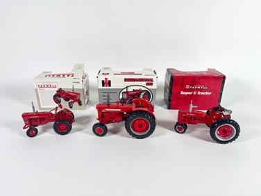 Lot of three McCormick Farmall and International Tractors by Ertl with boxes