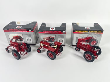 Lot of three International Harvester McCormick Farmall tractors by SpecCast with boxes