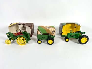 Lot of three John Deere tractors by Ertl with boxes