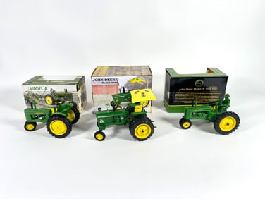 Lot of three John Deere tractors by Ertl with boxes