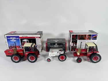 Lot of three McCormick Farmall and International tractors by Ertl with boxes