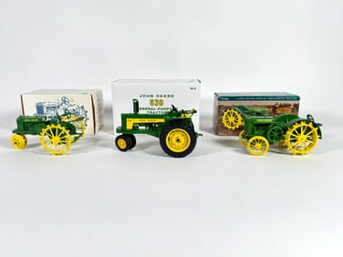 Lot of three John Deere tractors by Ertl with boxes