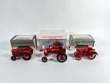 Lot of three McCormick Deering and McCormick Farmall tractors by SpecCast with boxes