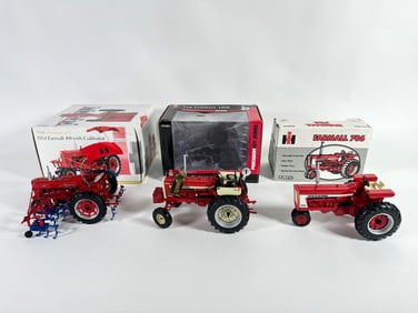 Lot of three McCormick Farmall tractors by Ertl with boxes