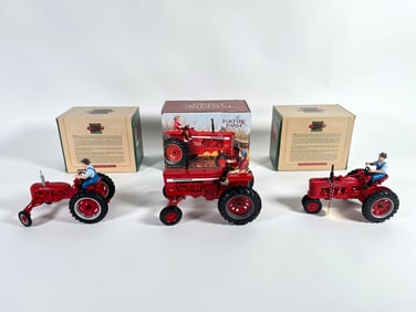 Lot of three McCormick Farmall and International tractors by Ertl with boxes