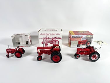 Lot of three McCormick and McCormick Farmall tractors by Ertl with boxes